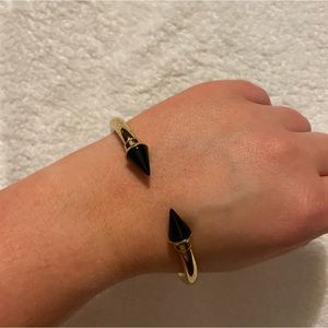 Barely used gold bracelet with black spikes